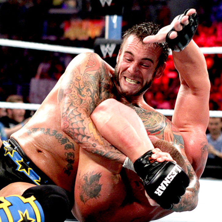 CM Punk applies the Anaconda Vice to Brock Lesnar